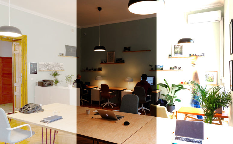 A modern office interior with desks and laptops.